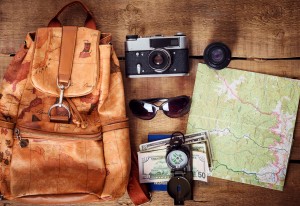 travel equipment - map, backpack, vintage camera, sunglasses, compass, passport and money